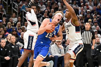 Nov 15, 2025; Boston, Massachusetts, USA; BYU Cougars guard Richie Saunders (15) reacts after being fouled by UConn Huskies guard Silas Demary Jr. (2) during the second half at TD Garden. Mandatory Credit: Eric Canha-Imagn Images