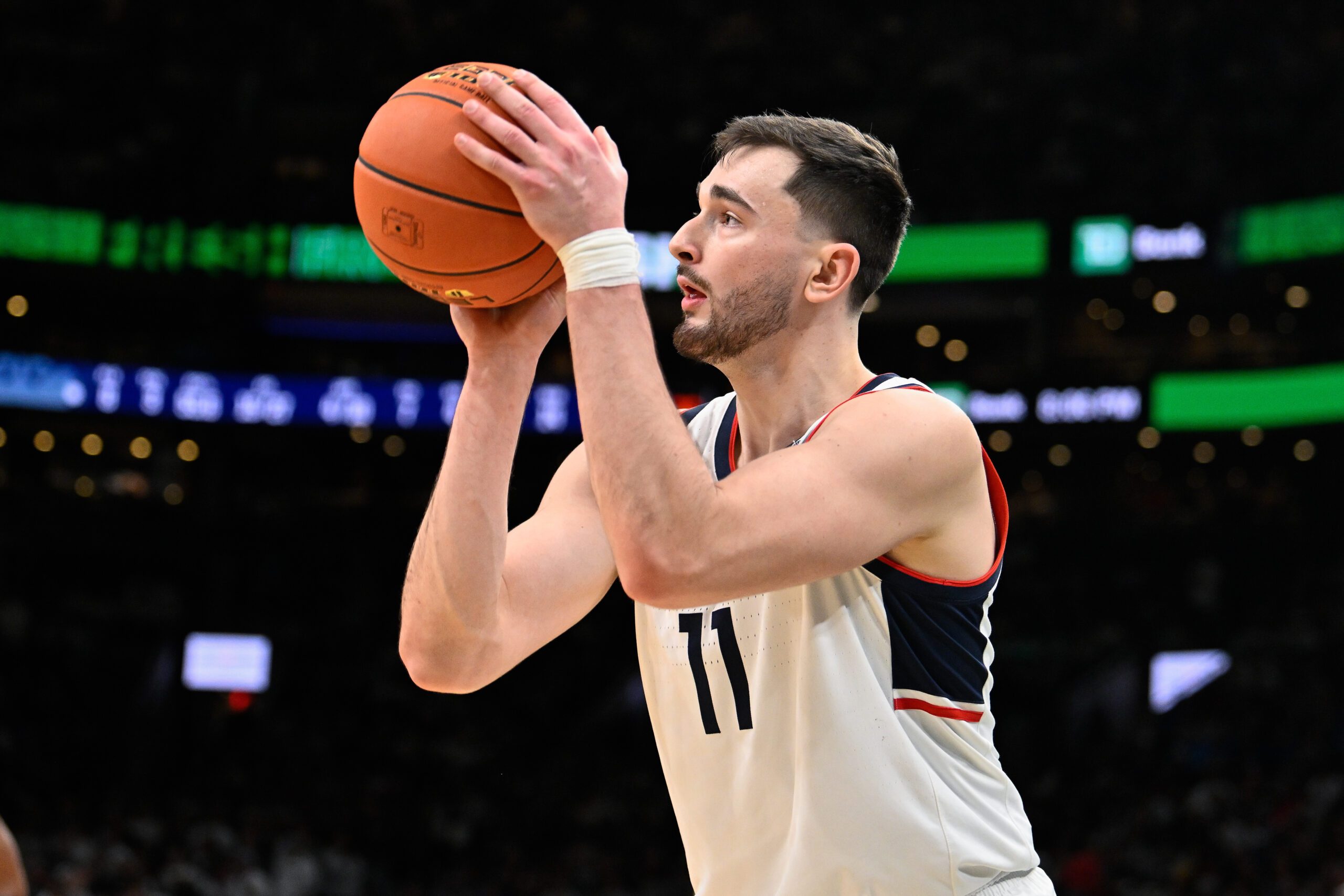 Nov 15, 2025; Boston, Massachusetts, USA; UConn Huskies forward Alex Karaban (11) makes a three point basket against the BYU Cougars during the first half at TD Garden. Mandatory Credit: Eric Canha-Imagn Images
