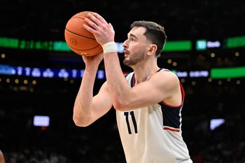 Nov 15, 2025; Boston, Massachusetts, USA; UConn Huskies forward Alex Karaban (11) makes a three point basket against the BYU Cougars during the first half at TD Garden. Mandatory Credit: Eric Canha-Imagn Images