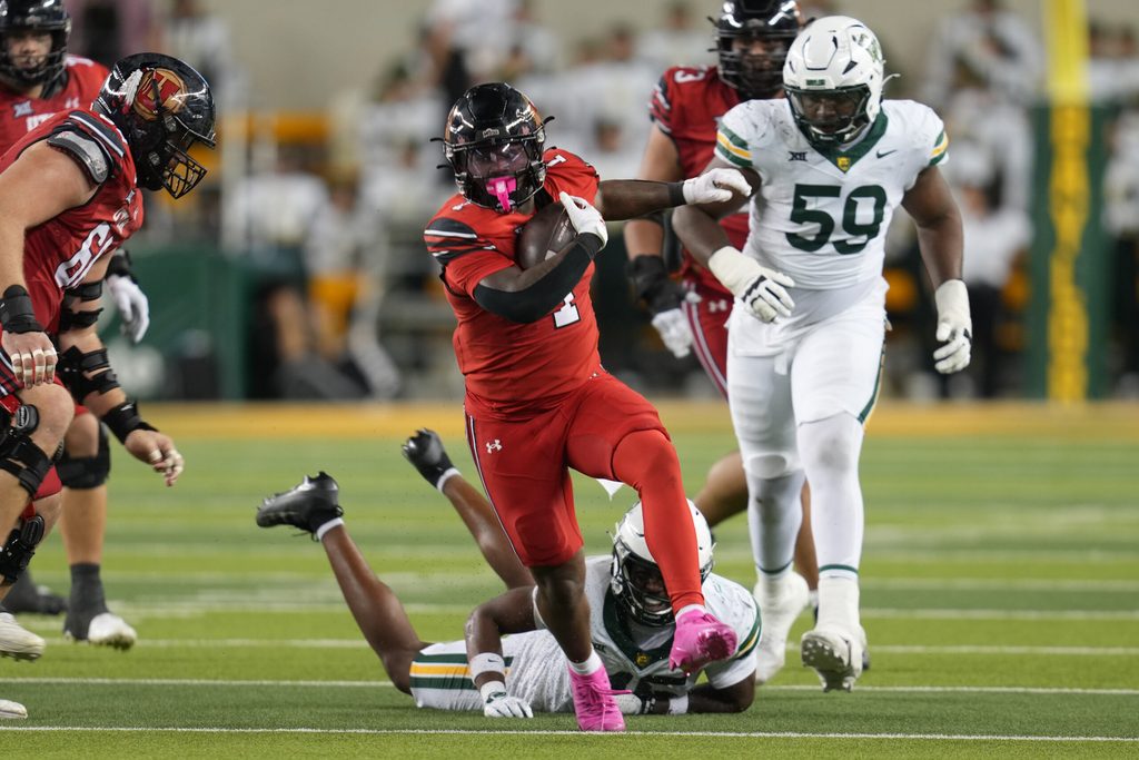Nov 15, 2025; Waco, Texas, USA; Utah Utes running back Wayshawn Parker (1) carries the ball ahead of Baylor Bears linebacker Kyland Reed (45) during the second half at McLane Stadium. Mandatory Credit: Chris Jones-Imagn Images