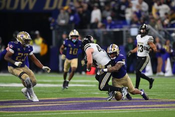 Nov 15, 2025; Seattle, Washington, USA; Washington Huskies linebacker Deven Bryant (17) tackles Purdue Boilermakers tight end Christian Moore (44) during the second half at Husky Stadium. Mandatory Credit: Steven Bisig-Imagn Images