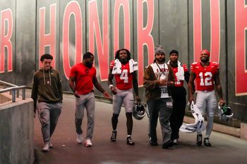 From left to right, R.J. Day, CJ Barnett, wide receiver Jeremiah Smith (4), J.T. Tuimoloau, linebacker C.J. Hicks (11) and running back CJ Donaldson Jr. (12) walk down the tunnel at halftime of the NCAA college football game at Ohio Stadium on Saturday, Nov. 15, 2025 in Columbus, Ohio.