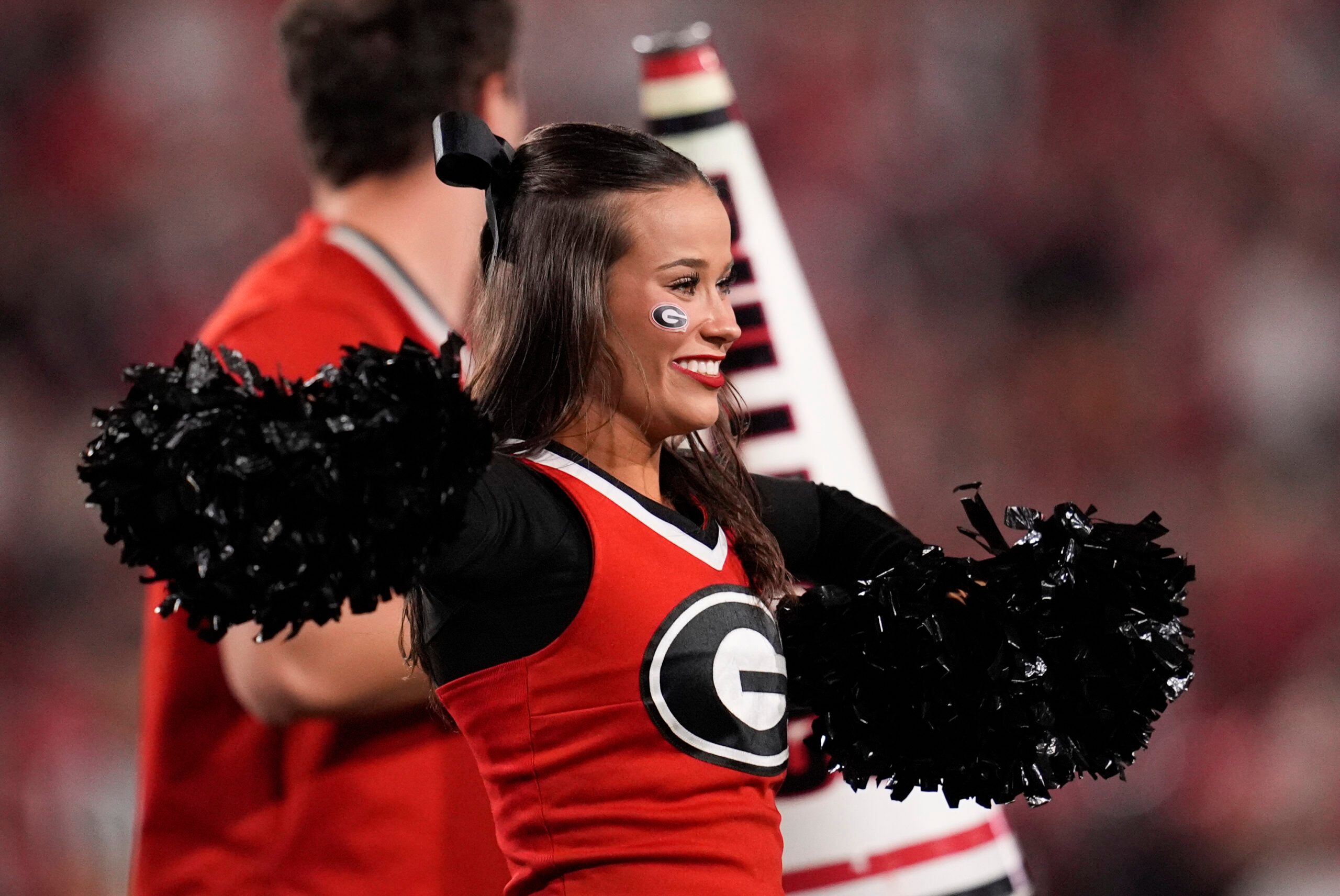 Nov 15, 2025; Athens, Georgia, USA; A Georgia Bulldogs cheerleader performs in the first half against the Texas Longhorns at Sanford Stadium. Mandatory Credit: Dale Zanine-Imagn Images