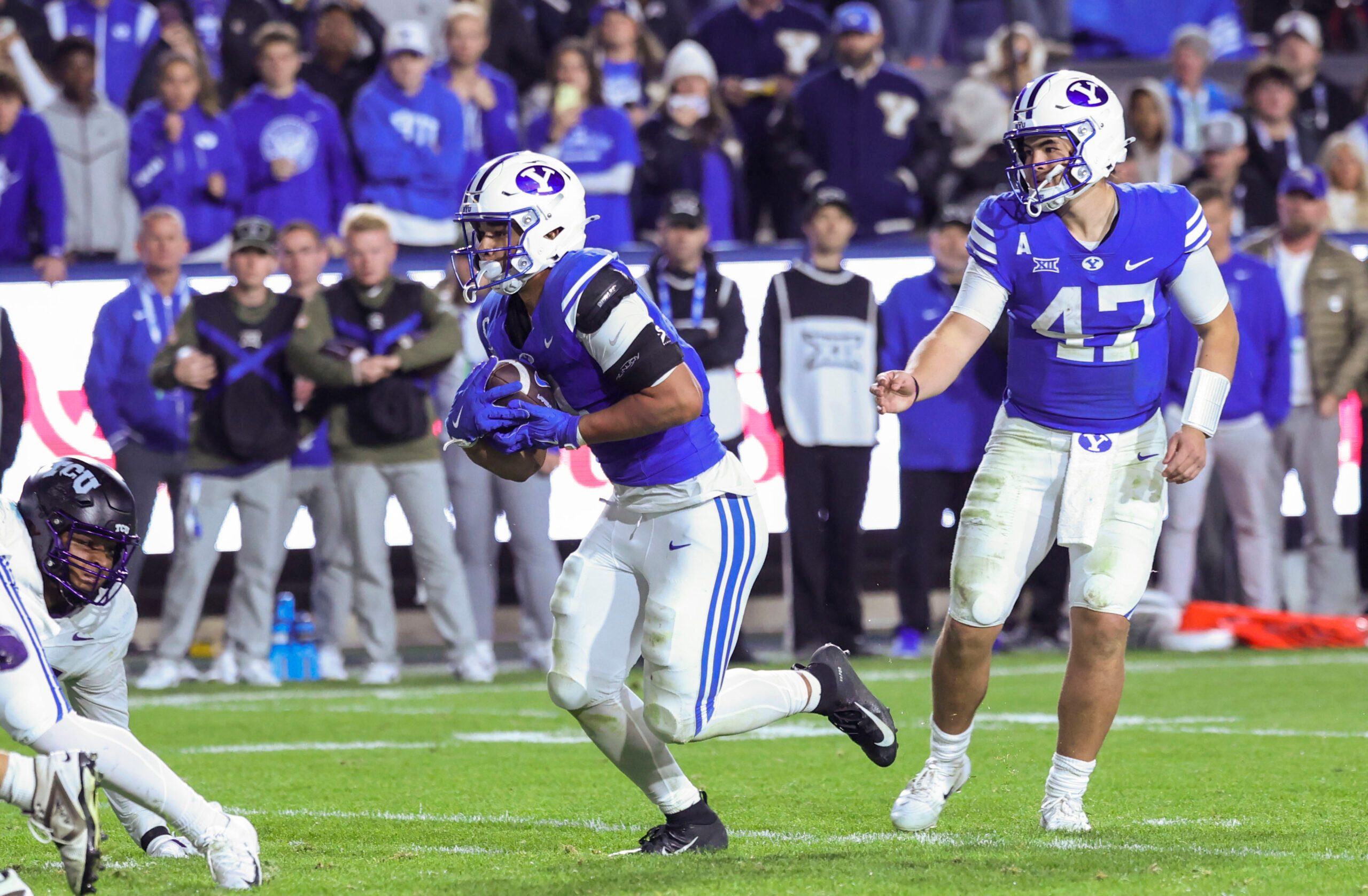 Nov 15, 2025; Provo, Utah, USA; BYU Cougars quarterback Bear Bachmeier (47) hands the ball off to running back LJ Martin (4) to score a touchdown against the Texas Christian University Horned Frogs during the fourth quarter at LaVell Edwards Stadium. Mandatory Credit: Rob Gray-Imagn Images