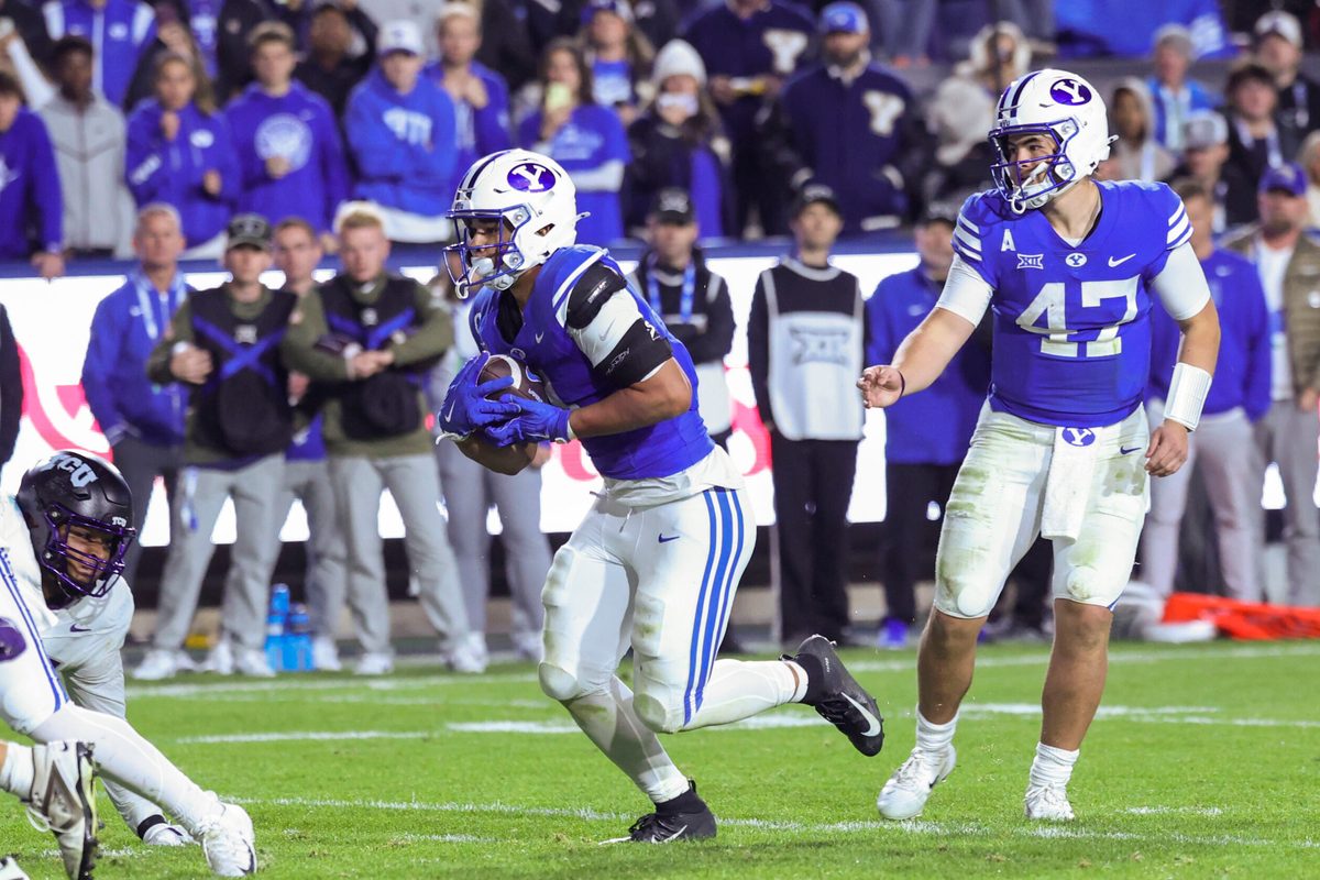 Nov 15, 2025; Provo, Utah, USA; BYU Cougars quarterback Bear Bachmeier (47) hands the ball off to running back LJ Martin (4) to score a touchdown against the Texas Christian University Horned Frogs during the fourth quarter at LaVell Edwards Stadium. Mandatory Credit: Rob Gray-Imagn Images