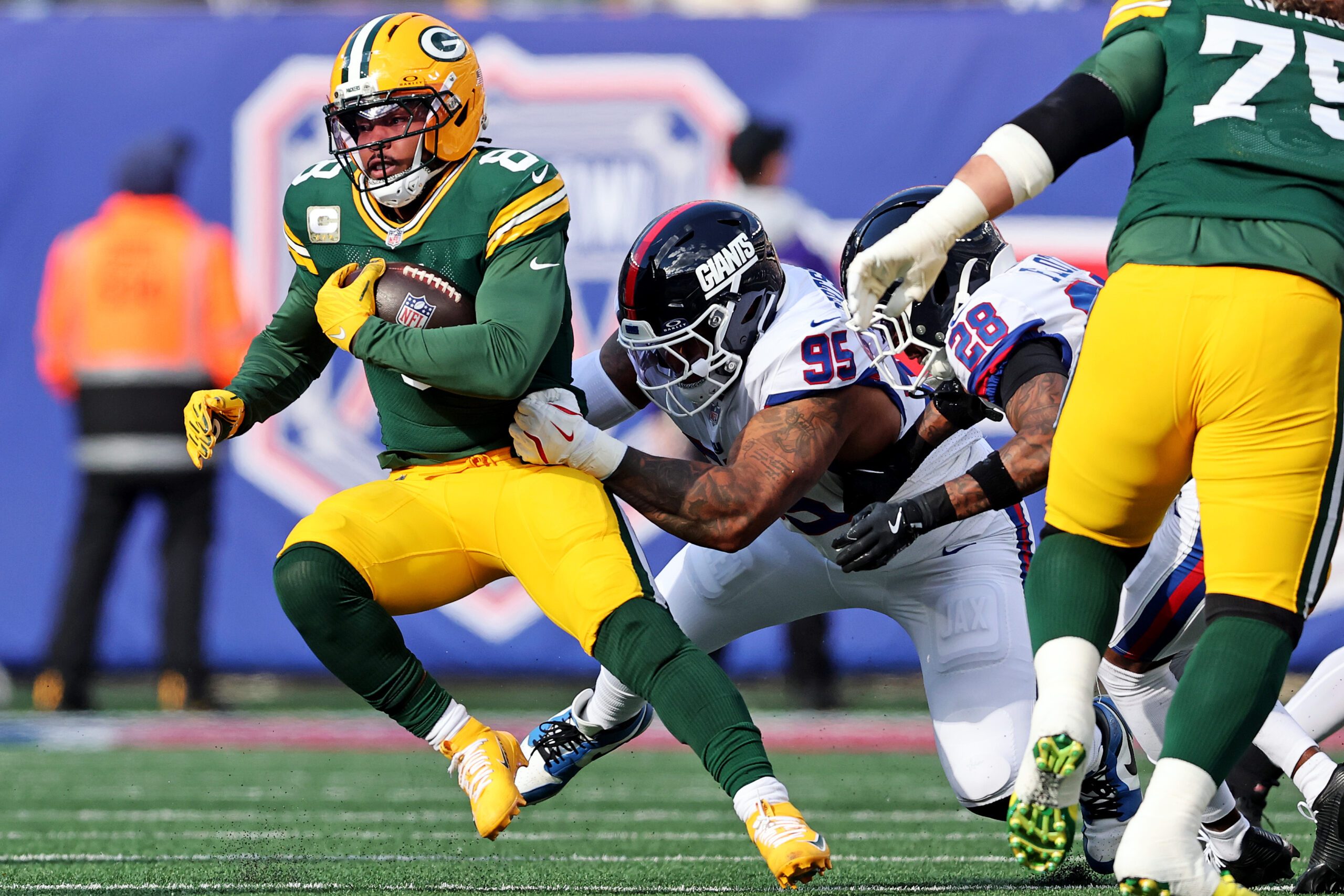Nov 16, 2025; East Rutherford, New Jersey, USA; Green Bay Packers running back Josh Jacobs (8) runs the ball against New York Giants defensive tackle Roy Robertson-Harris (95) during the first quarter at MetLife Stadium. Mandatory Credit: Vincent Carchietta-Imagn Images