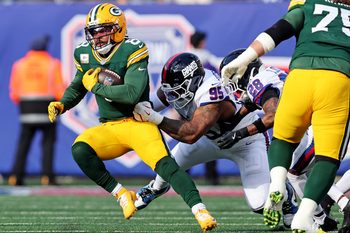 Nov 16, 2025; East Rutherford, New Jersey, USA; Green Bay Packers running back Josh Jacobs (8) runs the ball against New York Giants defensive tackle Roy Robertson-Harris (95) during the first quarter at MetLife Stadium. Mandatory Credit: Vincent Carchietta-Imagn Images