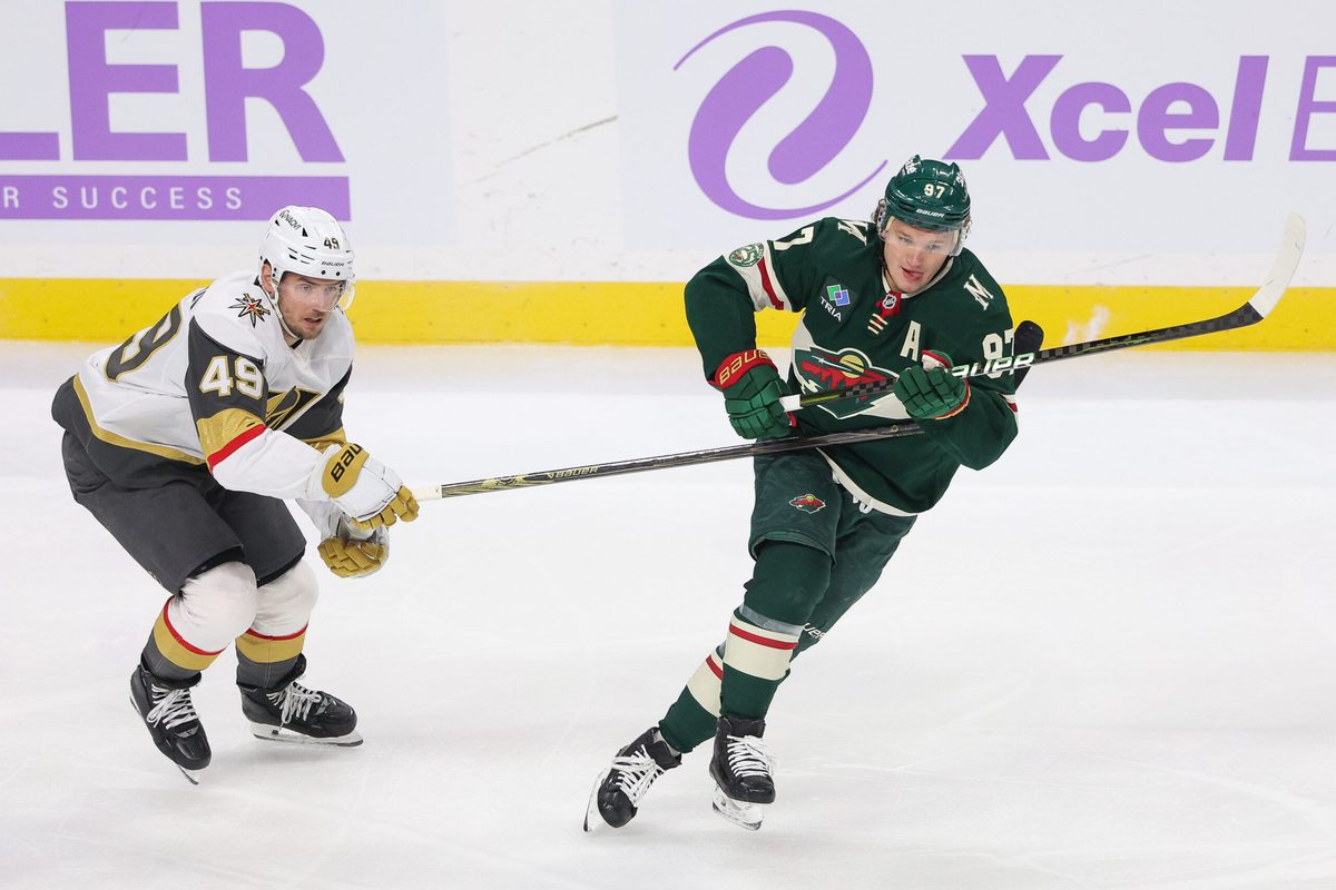 Nov 16, 2025; Saint Paul, Minnesota, USA; Minnesota Wild left wing Kirill Kaprizov (97) and Vegas Golden Knights left wing Ivan Barbashev (49) compete for the puck during the first period at Grand Casino Arena. Mandatory Credit: Matt Krohn-Imagn Images