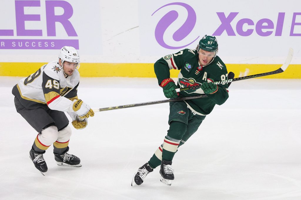 Nov 16, 2025; Saint Paul, Minnesota, USA; Minnesota Wild left wing Kirill Kaprizov (97) and Vegas Golden Knights left wing Ivan Barbashev (49) compete for the puck during the first period at Grand Casino Arena. Mandatory Credit: Matt Krohn-Imagn Images