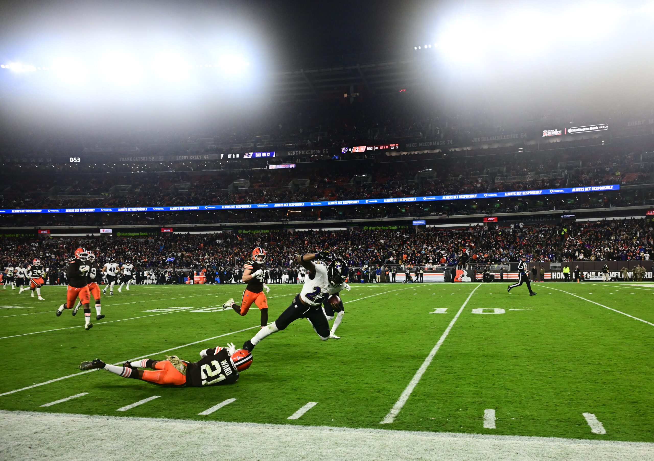 Nov 16, 2025; Cleveland, Ohio, USA; Baltimore Ravens running back Derrick Henry (22) is tackled by Cleveland Browns cornerback Denzel Ward (21) during the third quarter at Huntington Bank Field. Mandatory Credit: Ken Blaze-Imagn Images