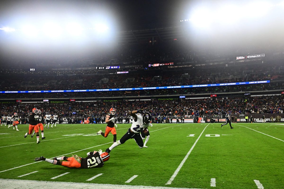 Nov 16, 2025; Cleveland, Ohio, USA; Baltimore Ravens running back Derrick Henry (22) is tackled by Cleveland Browns cornerback Denzel Ward (21) during the third quarter at Huntington Bank Field. Mandatory Credit: Ken Blaze-Imagn Images