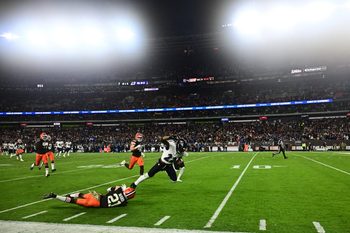Nov 16, 2025; Cleveland, Ohio, USA; Baltimore Ravens running back Derrick Henry (22) is tackled by Cleveland Browns cornerback Denzel Ward (21) during the third quarter at Huntington Bank Field. Mandatory Credit: Ken Blaze-Imagn Images