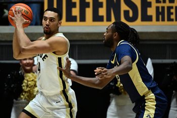 Nov 16, 2025; West Lafayette, Indiana, USA; Purdue Boilermakers forward Trey Kaufman-Renn (4) looks for an open teammate during the first half against the Akron Zips at Mackey Arena. Mandatory Credit: Marc Lebryk-Imagn Images