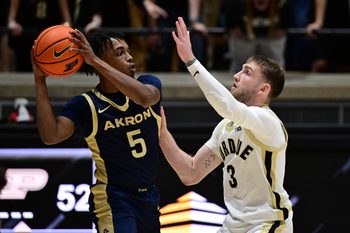 Nov 16, 2025; West Lafayette, Indiana, USA; Akron Zips guard Tavari Johnson (5) looks to get past Purdue Boilermakers guard Braden Smith (3) during the second half at Mackey Arena. Mandatory Credit: Marc Lebryk-Imagn Images