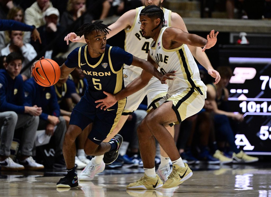 Nov 16, 2025; West Lafayette, Indiana, USA; Akron Zips guard Tavari Johnson (5) drives past Purdue Boilermakers guard C.J. Cox (0) during the second half at Mackey Arena. Mandatory Credit: Marc Lebryk-Imagn Images