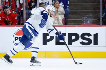 Nov 15, 2025; Chicago, Illinois, USA; Toronto Maple Leafs defenseman Oliver Ekman-Larsson (95) shoots against the Chicago Blackhawks during the first period at United Center. Mandatory Credit: Kamil Krzaczynski-Imagn Images