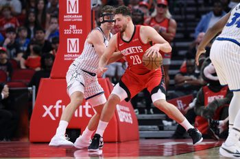 Nov 16, 2025; Houston, Texas, USA; Houston Rockets center Alperen Sengun (28) controls the ball as Orlando Magic forward Franz Wagner (22) defends during the fourth quarter at Toyota Center. Mandatory Credit: Troy Taormina-Imagn Images