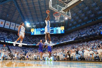 Nov 7, 2025; Chapel Hill, North Carolina, USA; North Carolina Tar Heels forward Caleb Wilson (8) dunks the ball as guard Seth Trimble (7) jumps in the background near the end of the second half at Dean E. Smith Center. Mandatory Credit: Bob Donnan-Imagn Images