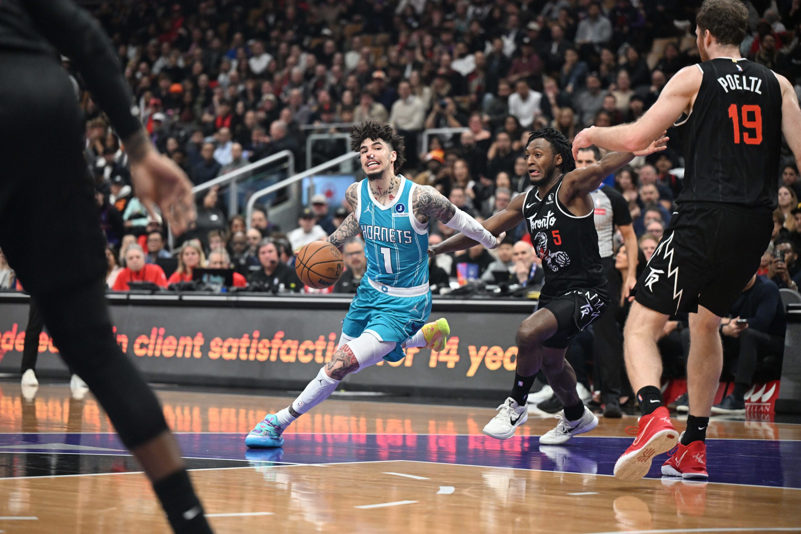 Nov 17, 2025; Toronto, Ontario, CAN; Charlotte Hornets guard LaMelo Ball (1) dribbles the ball past Toronto Raptors guard Immanuel Quickley (5) in the second half at Scotiabank Arena. Mandatory Credit: Dan Hamilton-Imagn Images
