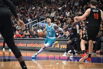 Nov 17, 2025; Toronto, Ontario, CAN;  Charlotte Hornets guard LaMelo Ball (1) dribbles the ball past Toronto Raptors guard Immanuel Quickley (5) in the second half at Scotiabank Arena. Mandatory Credit: Dan Hamilton-Imagn Images