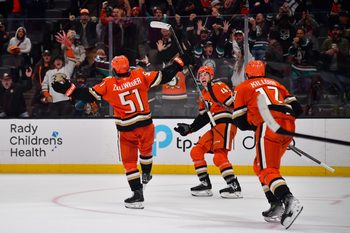Nov 17, 2025; Anaheim, California, USA; Anaheim Ducks defenseman Olen Zellweger (51) celebrates his goal scored against the Utah Mammoth with right wing Beckett Sennecke (45) and left wing Alex Killorn (17) against the Utah Mammoth in the overtime period at Honda Center. Mandatory Credit: Gary A. Vasquez-Imagn Images