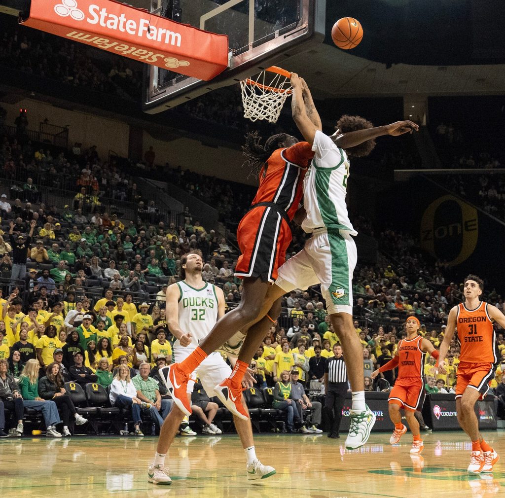 Oregon State’s Yaak Yaak, left, fouls Oregon’s Devon Pryor as he tries for a dunk in the closing moments of the game at Matthew Knight Arena in Eugene Nov. 17, 2025.