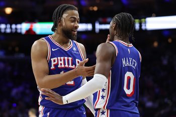 Nov 17, 2025; Philadelphia, Pennsylvania, USA; Philadelphia 76ers forward Trendon Watford (12) and guard Tyrese Maxey (0) during the fourth quarter against the LA Clippers at Xfinity Mobile Arena. Mandatory Credit: Bill Streicher-Imagn Images