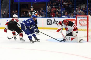 Nov 18, 2025; Tampa, Florida, USA; Tampa Bay Lightning center Jake Guentzel (59) shoots as New Jersey Devils goaltender Jacob Markstrom (25) makes a save during the third period at Benchmark International Arena. Mandatory Credit: Kim Klement Neitzel-Imagn Images