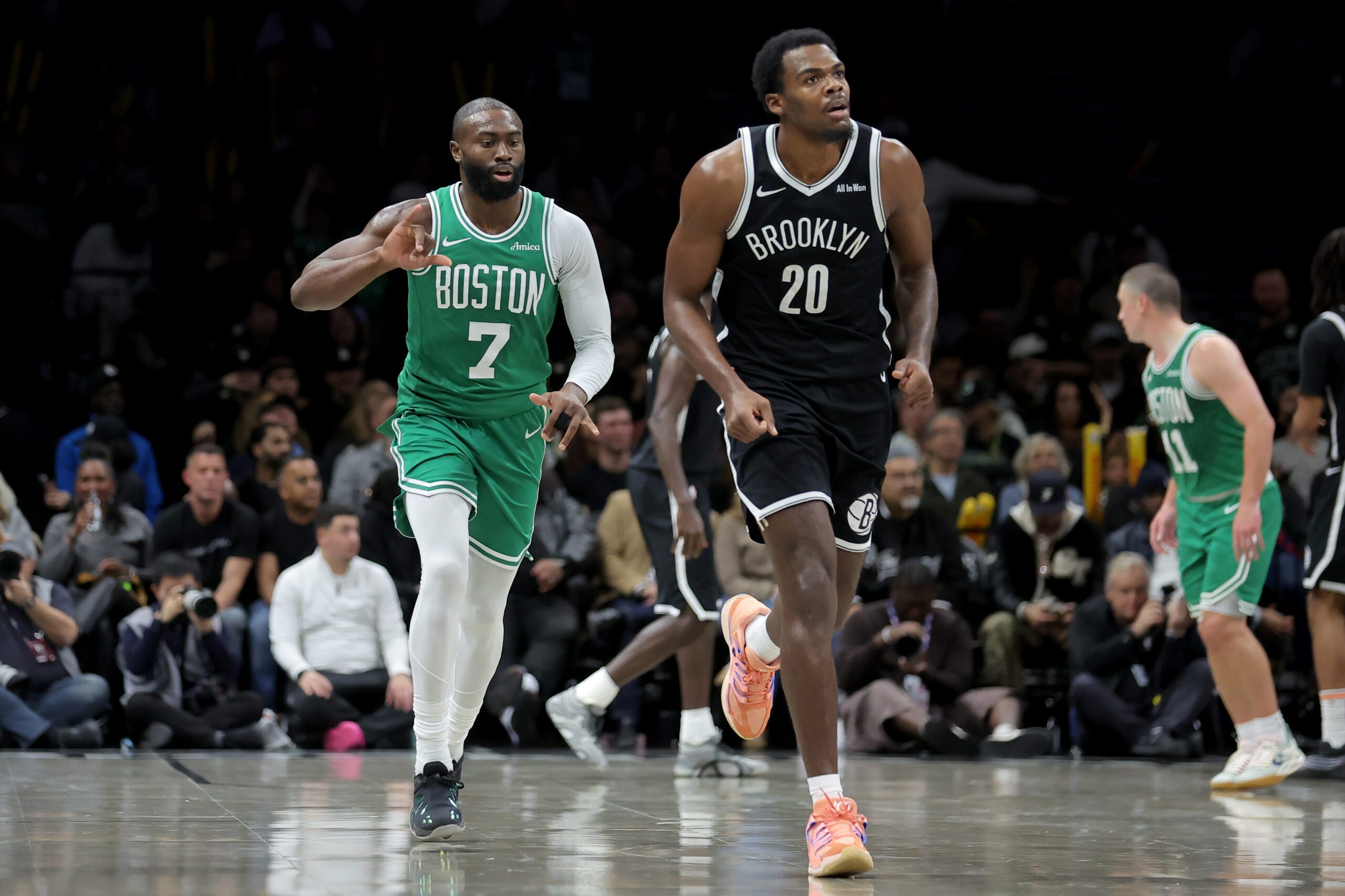 Nov 18, 2025; Brooklyn, New York, USA; Boston Celtics guard Jaylen Brown (7) celebrates his three point shot against Brooklyn Nets center Day'Ron Sharpe (20) during the third quarter at Barclays Center. Mandatory Credit: Brad Penner-Imagn Images