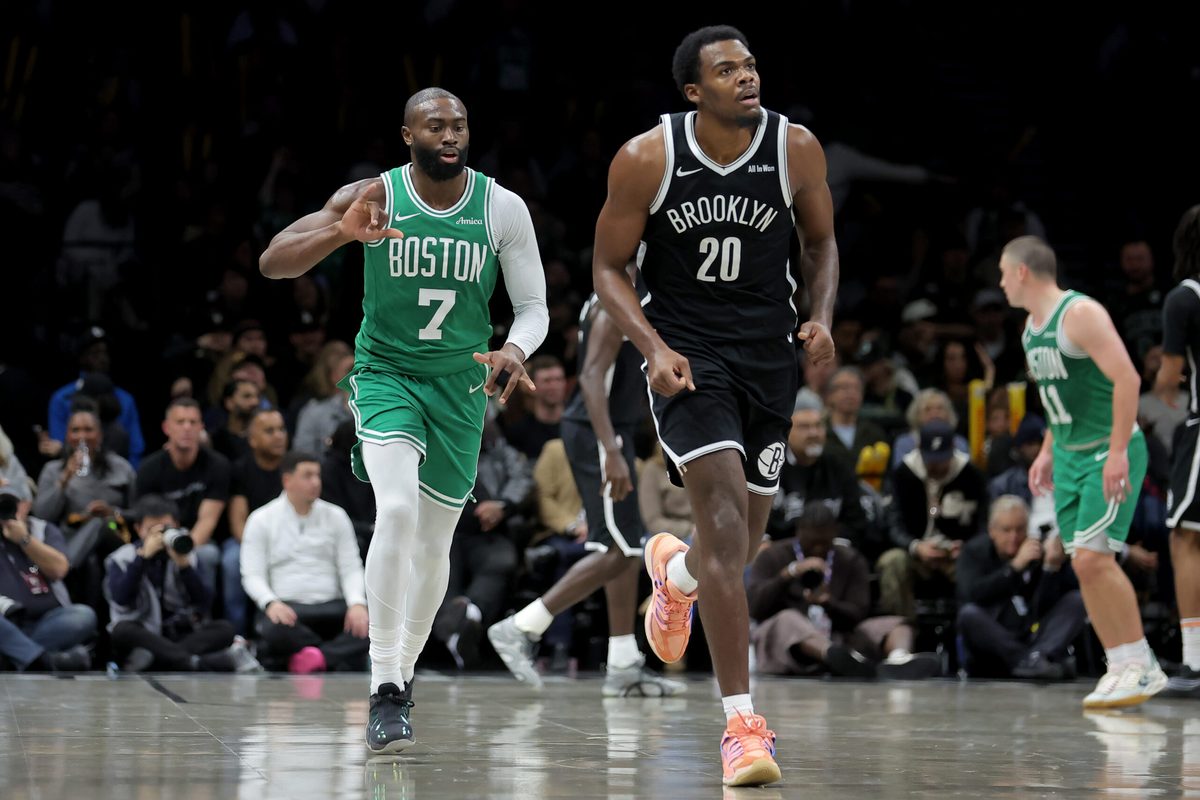 Nov 18, 2025; Brooklyn, New York, USA; Boston Celtics guard Jaylen Brown (7) celebrates his three point shot against Brooklyn Nets center Day'Ron Sharpe (20) during the third quarter at Barclays Center. Mandatory Credit: Brad Penner-Imagn Images
