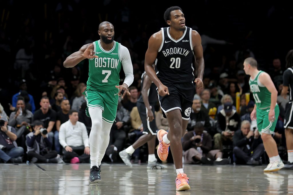 Nov 18, 2025; Brooklyn, New York, USA; Boston Celtics guard Jaylen Brown (7) celebrates his three point shot against Brooklyn Nets center Day'Ron Sharpe (20) during the third quarter at Barclays Center. Mandatory Credit: Brad Penner-Imagn Images