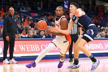 Nov 18, 2025; Syracuse, New York, USA; Syracuse Orange guard J.J. Starling (2) drives against Monmouth Hawks forward Jason Rivera-Torres (1) during the second half at the JMA Wireless Dome. Mandatory Credit: Rich Barnes-Imagn Images