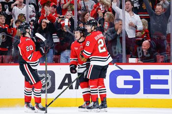 Nov 18, 2025; Chicago, Illinois, USA; Chicago Blackhawks center Connor Bedard (98) celebrates with teammates after scoring against the Calgary Flames during the second period at United Center. Mandatory Credit: Kamil Krzaczynski-Imagn Images