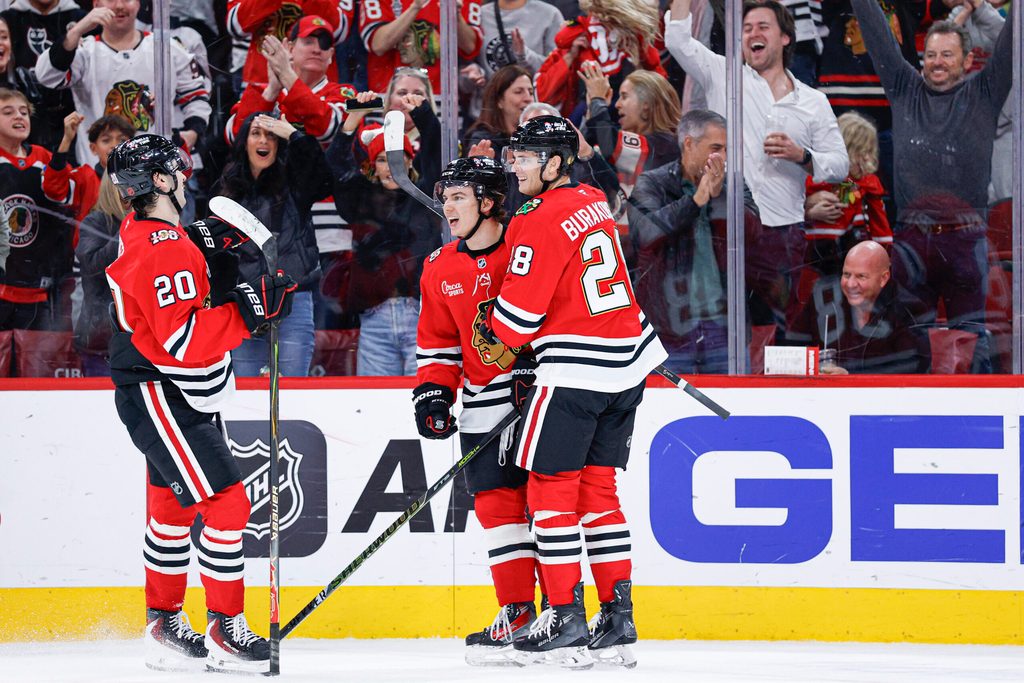 Nov 18, 2025; Chicago, Illinois, USA; Chicago Blackhawks center Connor Bedard (98) celebrates with teammates after scoring against the Calgary Flames during the second period at United Center. Mandatory Credit: Kamil Krzaczynski-Imagn Images