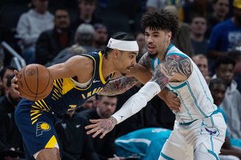 Nov 19, 2025; Indianapolis, Indiana, USA; Indiana Pacers guard Andrew Nembhard (2) dribbles the ball while Charlotte Hornets guard LaMelo Ball (1) defends in the first half at Gainbridge Fieldhouse. Mandatory Credit: Trevor Ruszkowski-Imagn Images