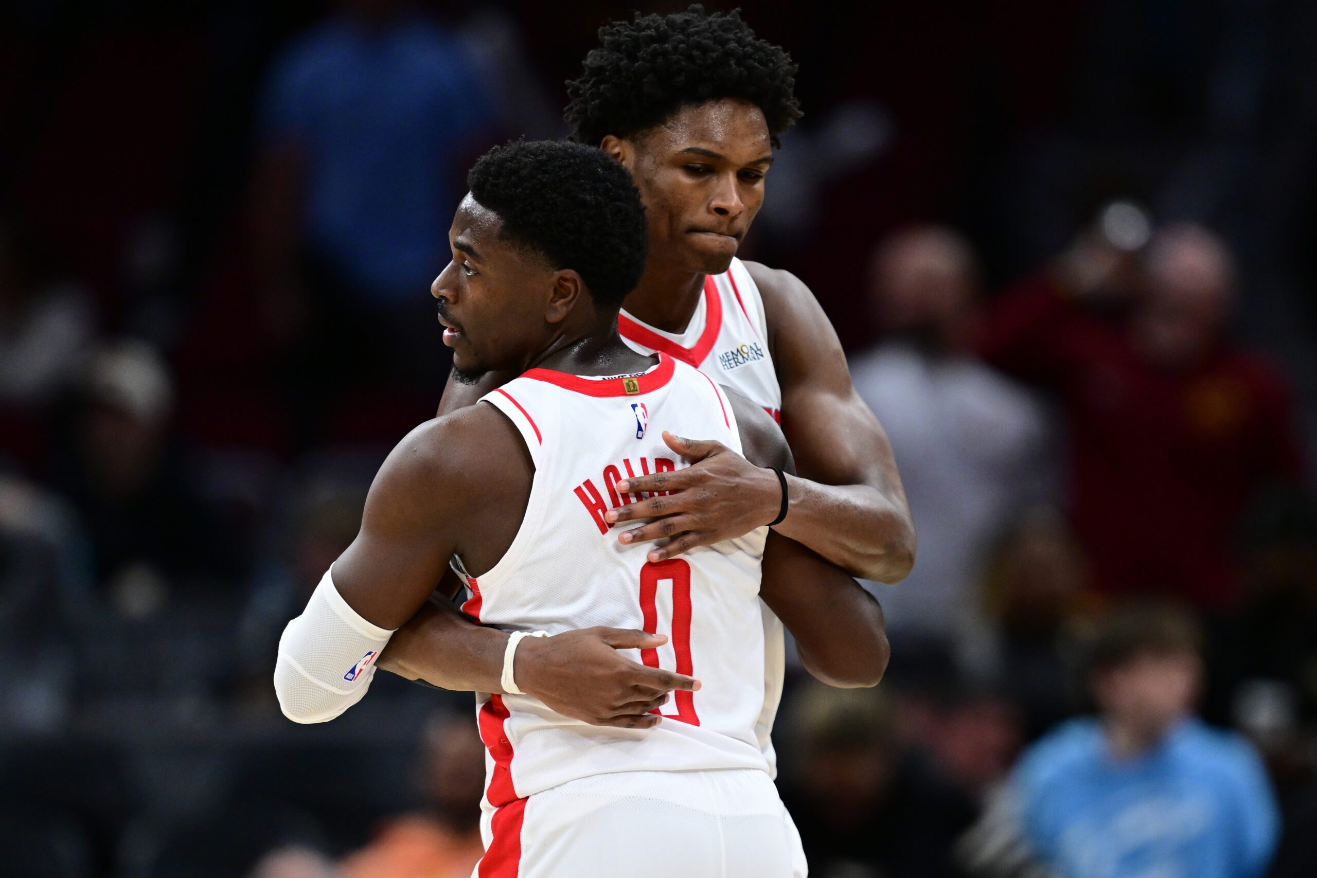 Nov 19, 2025; Cleveland, Ohio, USA; Houston Rockets guard Amen Thompson (1) hugs Houston Rockets guard Aaron Holiday (0) after the Rockets defeated the Cleveland Cavaliers at Rocket Arena. Mandatory Credit: David Dermer-Imagn Images