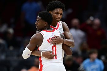 Nov 19, 2025; Cleveland, Ohio, USA; Houston Rockets guard Amen Thompson (1) hugs Houston Rockets guard Aaron Holiday (0) after the Rockets defeated the Cleveland Cavaliers at Rocket Arena. Mandatory Credit: David Dermer-Imagn Images