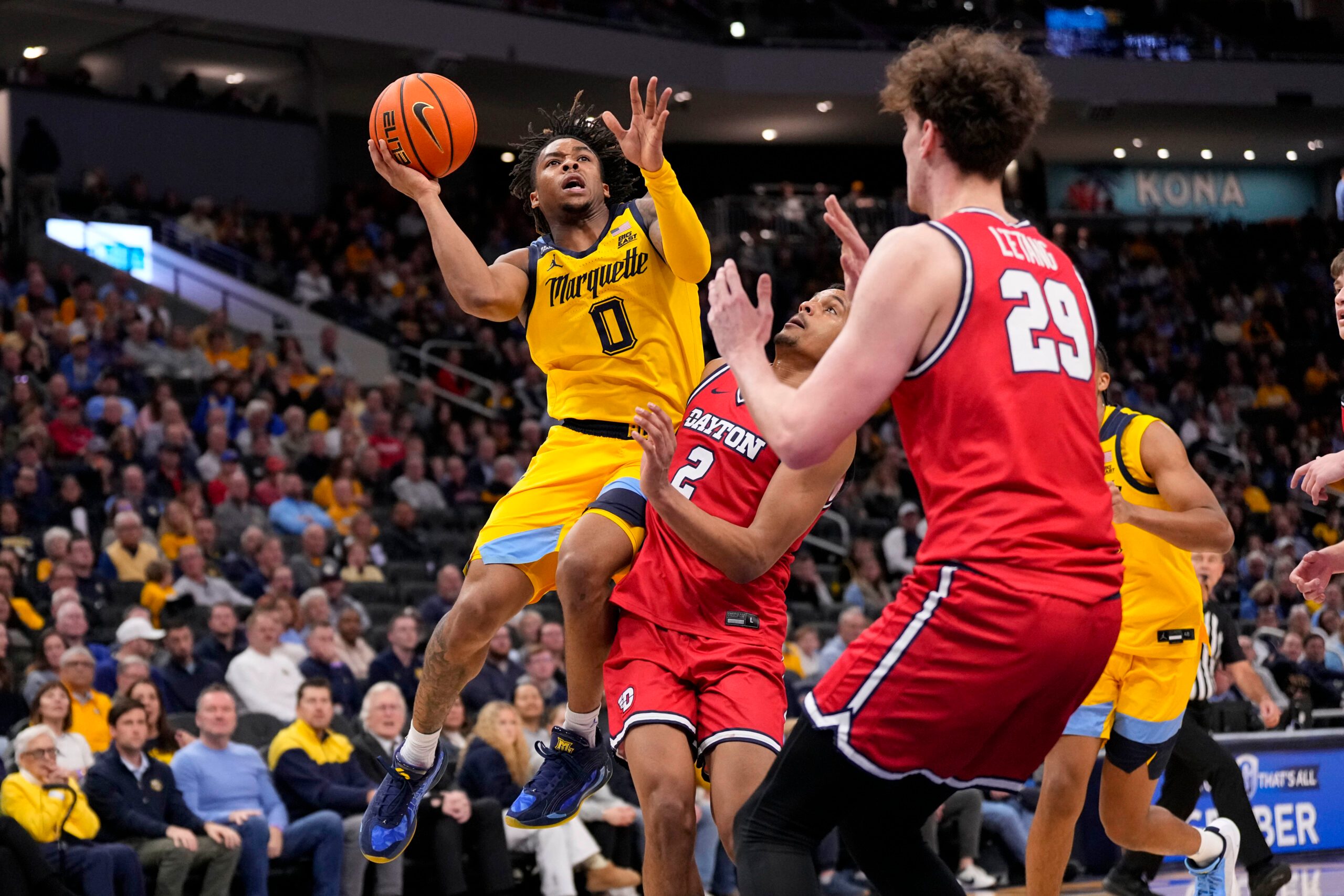 Nov 19, 2025; Milwaukee, Wisconsin, USA;  Marquette Golden Eagles guard Nigel James Jr. (0) shoots over Dayton Flyers guard De'Shayne Montgomery (2) during the second half at Fiserv Forum. Mandatory Credit: Jeff Hanisch-Imagn Images
