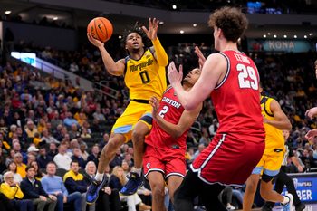 Nov 19, 2025; Milwaukee, Wisconsin, USA;  Marquette Golden Eagles guard Nigel James Jr. (0) shoots over Dayton Flyers guard De'Shayne Montgomery (2) during the second half at Fiserv Forum. Mandatory Credit: Jeff Hanisch-Imagn Images