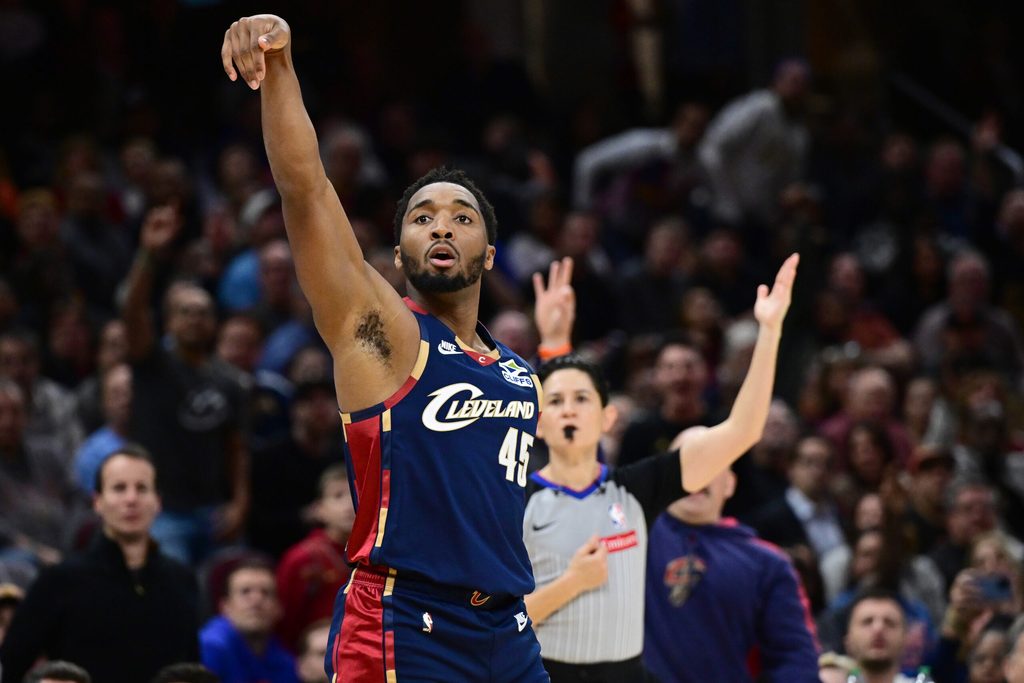 Nov 19, 2025; Cleveland, Ohio, USA; Cleveland Cavaliers guard Donovan Mitchell (45) shoots a three point shot surging the second half against the Houston Rockets at Rocket Arena. Mandatory Credit: David Dermer-Imagn Images