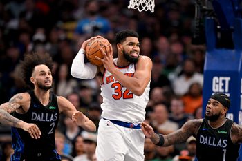 Nov 19, 2025; Dallas, Texas, USA; New York Knicks center Karl-Anthony Towns (32) grabs a rebound in front of Dallas Mavericks center Dereck Lively II (2) and guard Jaden Hardy (1) during the second half at the American Airlines Center. Mandatory Credit: Jerome Miron-Imagn Images