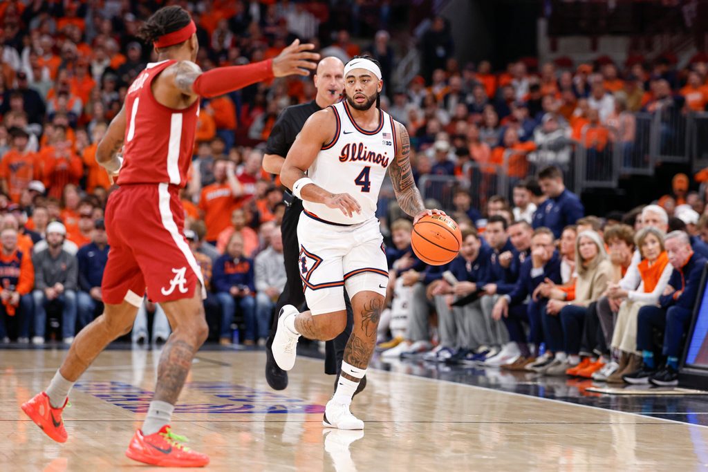 Nov 19, 2025; Chicago, Illinois, USA; Illinois Fighting Illini guard Kylan Boswell (4) brings the ball up court against Alabama Crimson Tide guard Labaron Philon (0) during the first half at United Center. Mandatory Credit: Kamil Krzaczynski-Imagn Images