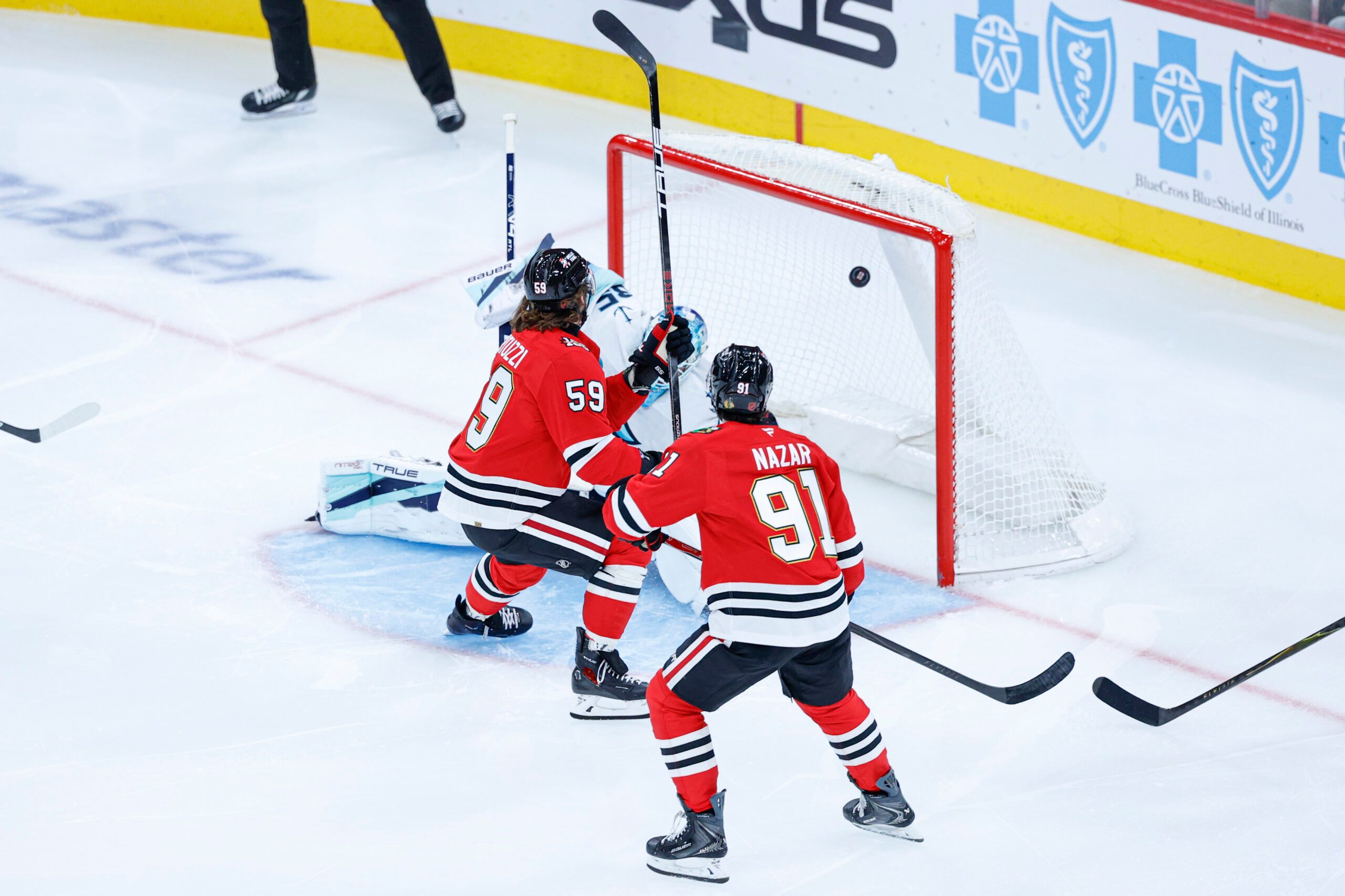 Nov 20, 2025; Chicago, Illinois, USA; Chicago Blackhawks left wing Tyler Bertuzzi (59) scores against Seattle Kraken goaltender Joey Daccord (35) during the second period at United Center. Mandatory Credit: Kamil Krzaczynski-Imagn Images