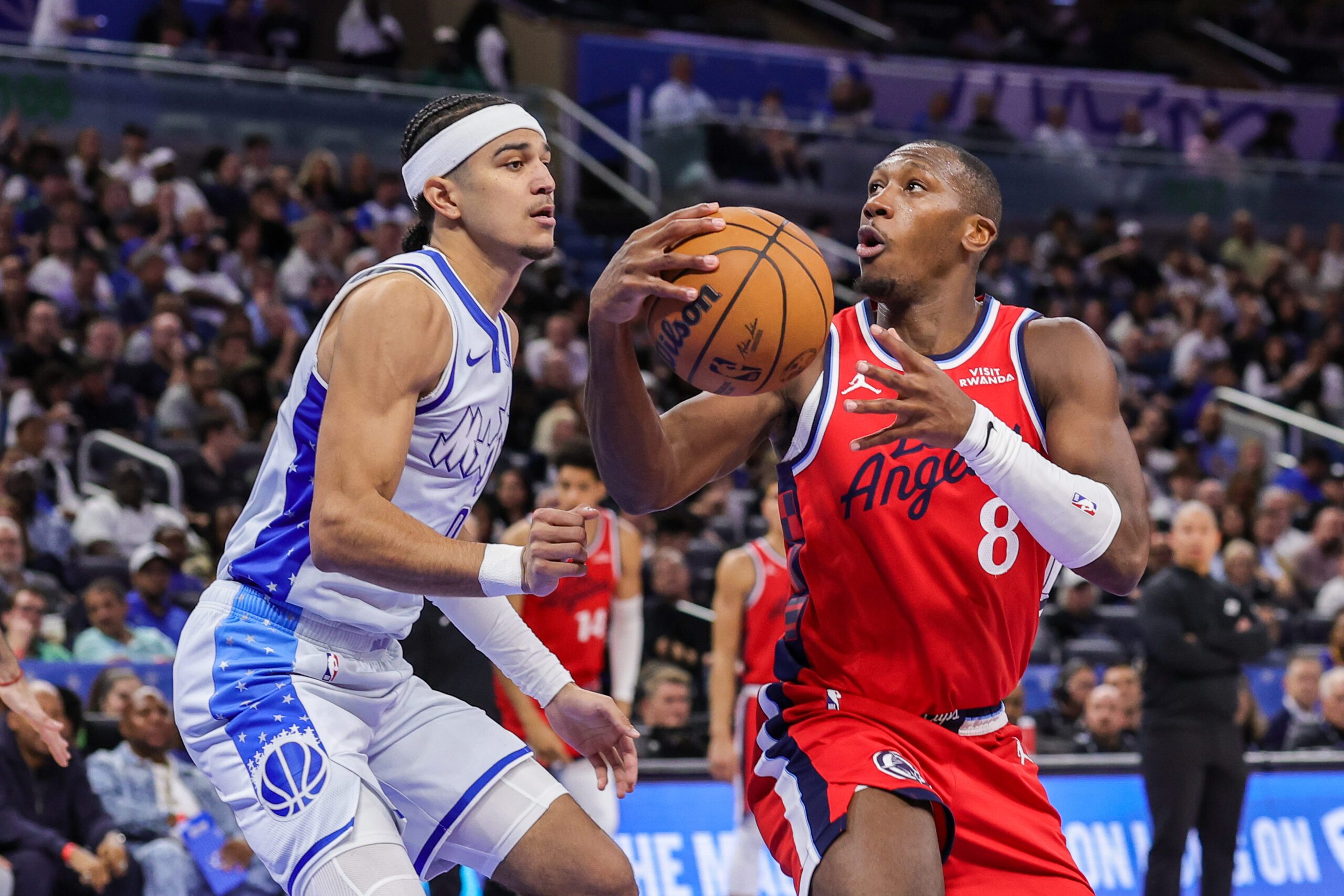 Nov 20, 2025; Orlando, Florida, USA; LA Clippers guard Kris Dunn (8) controls the ball in front of Orlando Magic guard Anthony Black (0) during the second half at Kia Center. Mandatory Credit: Mike Watters-Imagn Images