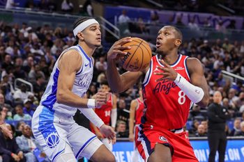 Nov 20, 2025; Orlando, Florida, USA; LA Clippers guard Kris Dunn (8) controls the ball in front of Orlando Magic guard Anthony Black (0) during the second half at Kia Center. Mandatory Credit: Mike Watters-Imagn Images