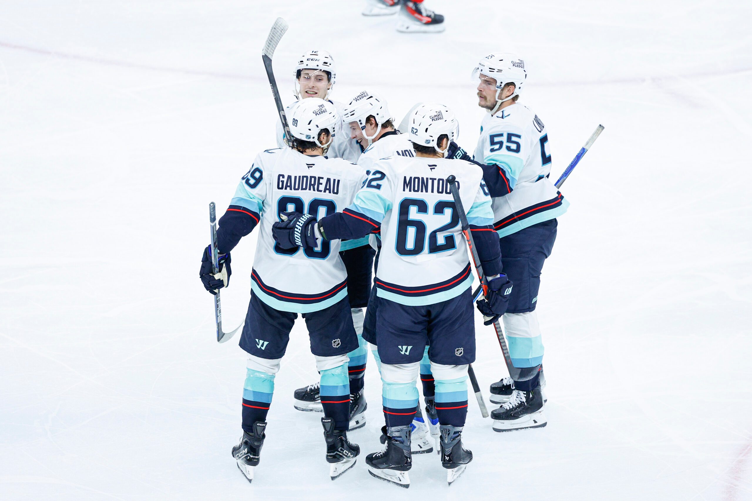 Nov 20, 2025; Chicago, Illinois, USA; Seattle Kraken left wing Tye Kartye (12) celebrates with teammates after scoring against the Chicago Blackhawks during the third period at United Center. Mandatory Credit: Kamil Krzaczynski-Imagn Images