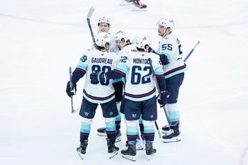 Nov 20, 2025; Chicago, Illinois, USA; Seattle Kraken left wing Tye Kartye (12) celebrates with teammates after scoring against the Chicago Blackhawks during the third period at United Center. Mandatory Credit: Kamil Krzaczynski-Imagn Images