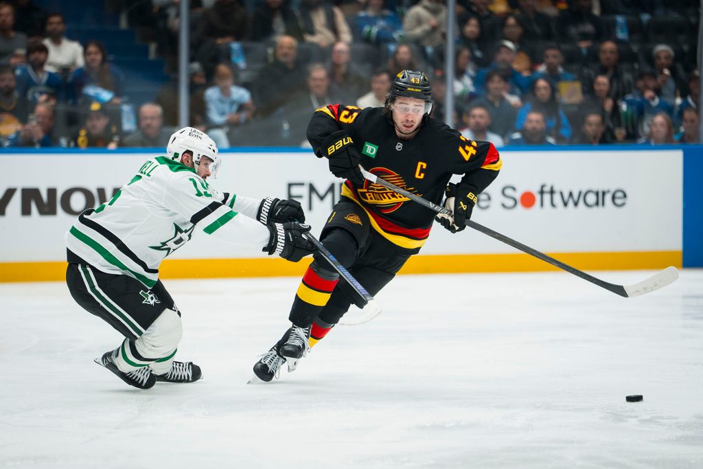 Nov 20, 2025; Vancouver, British Columbia, CAN; Vancouver Canucks defenseman Quinn Hughes (43) drives past Dallas Stars forward Colin Blackwell (15) in the second period at Rogers Arena. Mandatory Credit: Bob Frid-Imagn Images