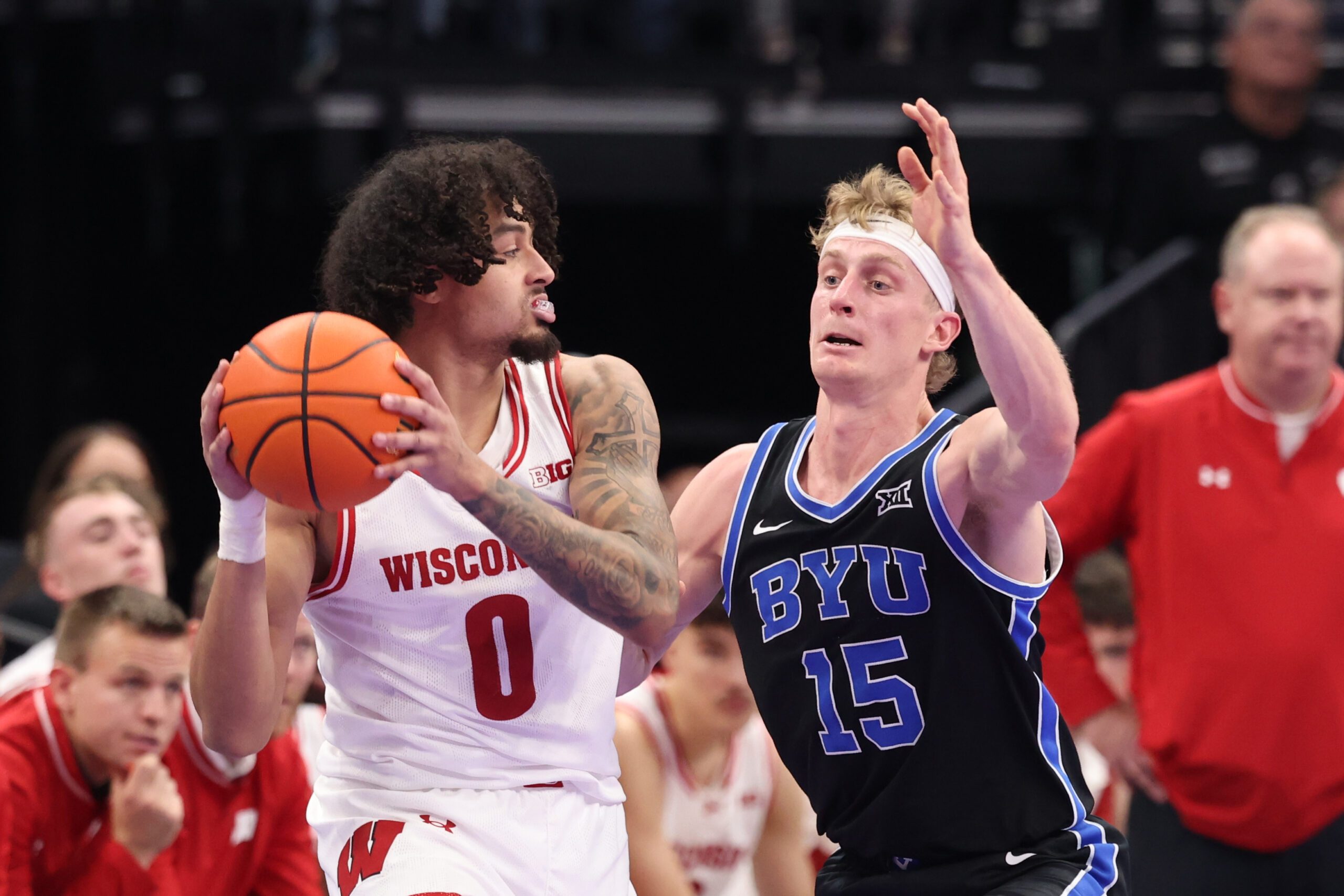 Nov 21, 2025; Salt Lake City, Utah, USA; Wisconsin Badgers guard Braeden Carrington (0) looks for the play against BYU Cougars guard Richie Saunders (15) during the second half at Delta Center. Mandatory Credit: Rob Gray-Imagn Images