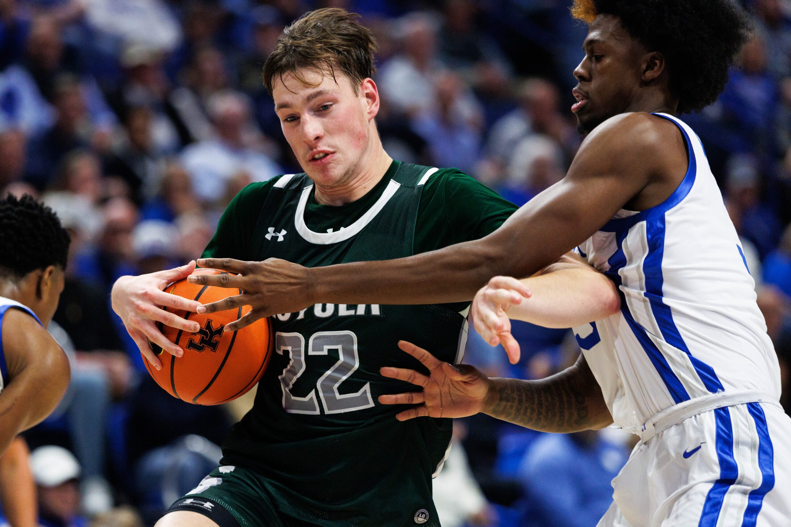 Nov 21, 2025; Lexington, Kentucky, USA; Loyola (MD) Greyhounds forward Sam Springer (22) drives to the basket against Kentucky Wildcats guard Kam Williams (3) during the first half at Rupp Arena at Central Bank Center. Mandatory Credit: Jordan Prather-Imagn Images